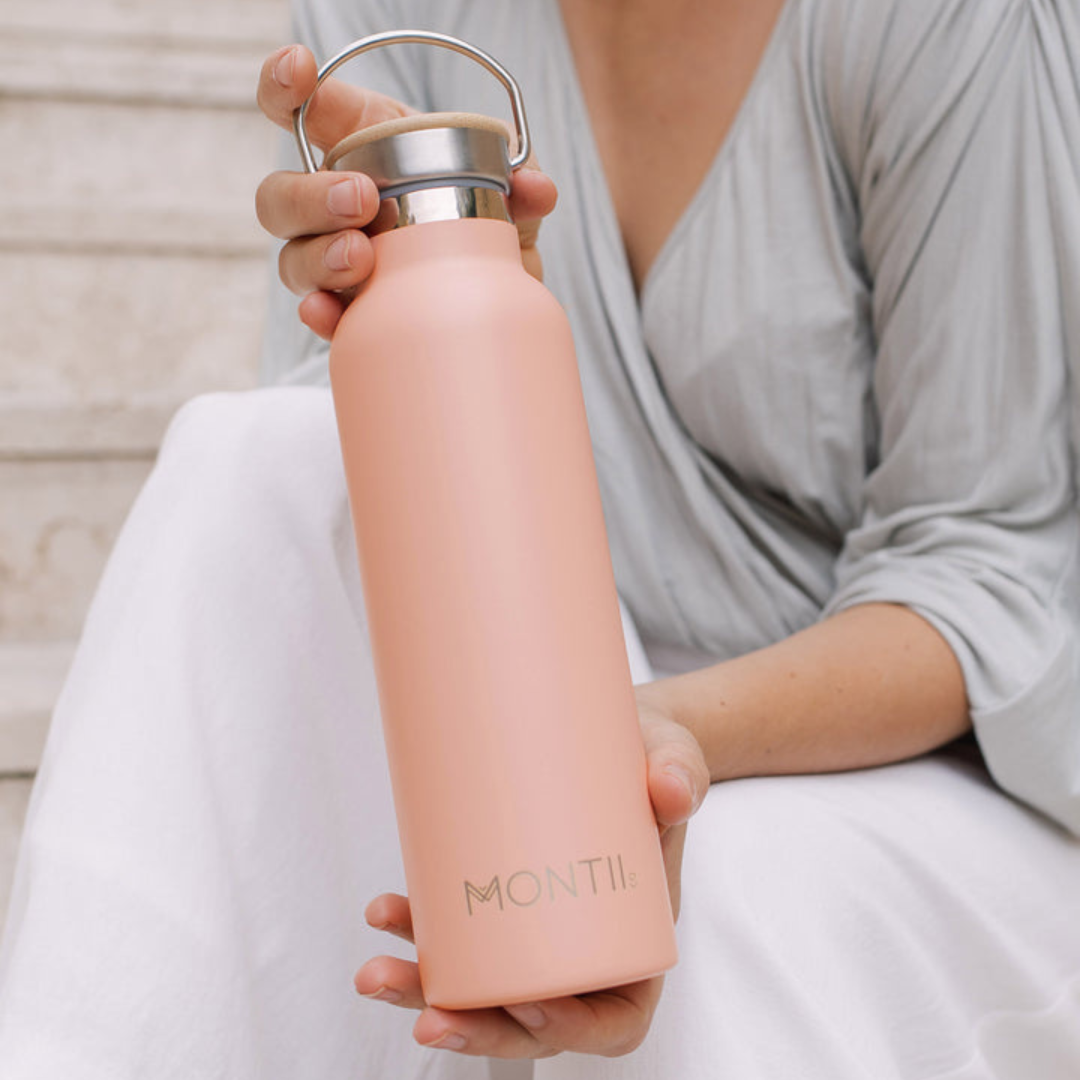 Dawn coloured Montii original drink bottle being held