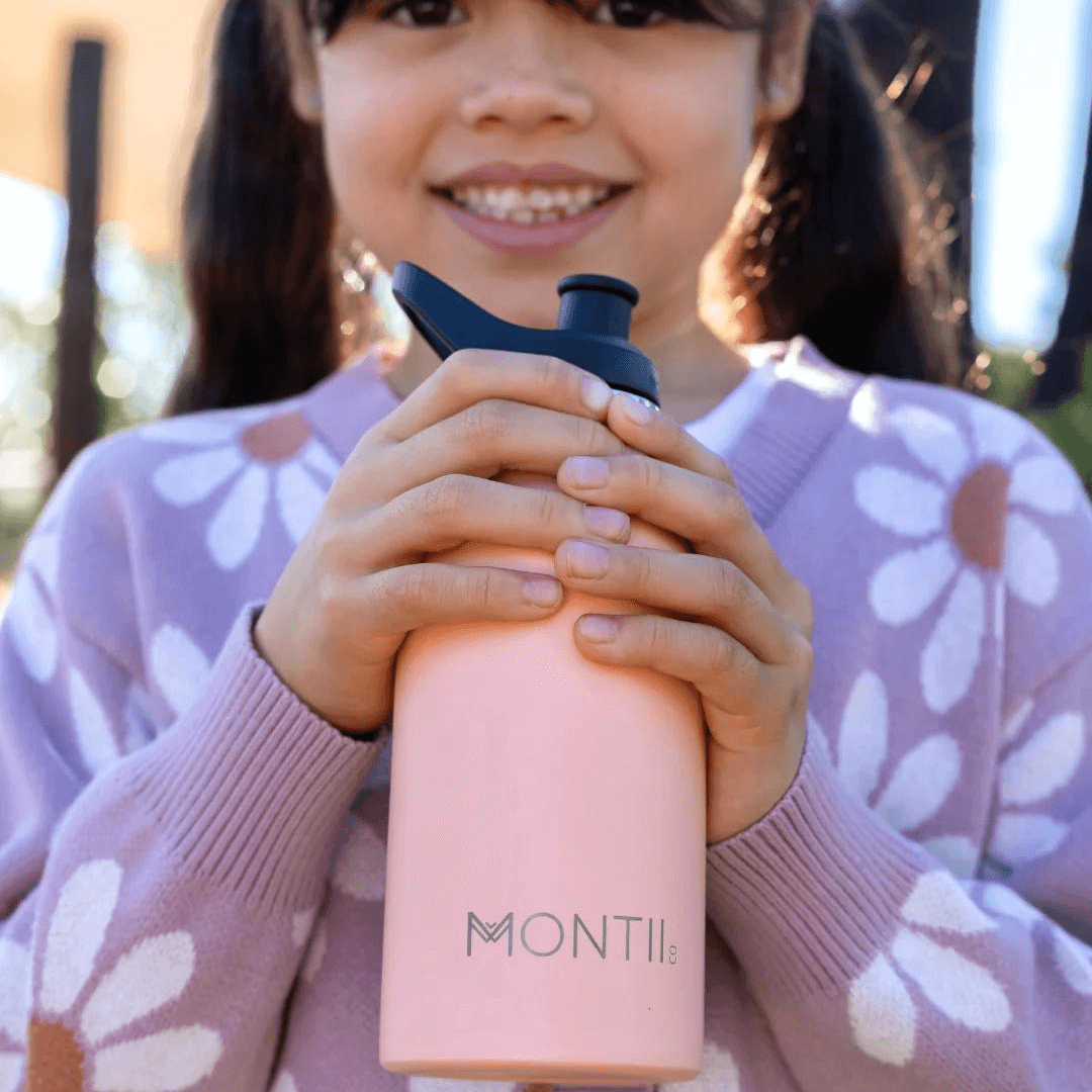 Little girl holding Montii NZ mini drink bottle in dawn colour
