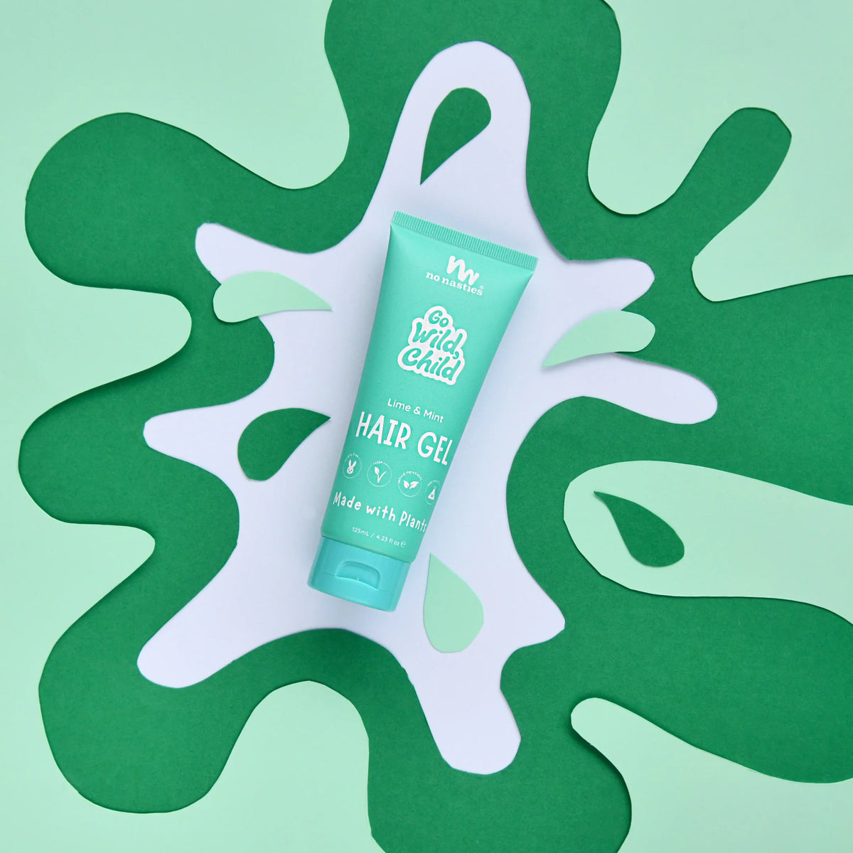 Green hair gel tube on a green abstract background