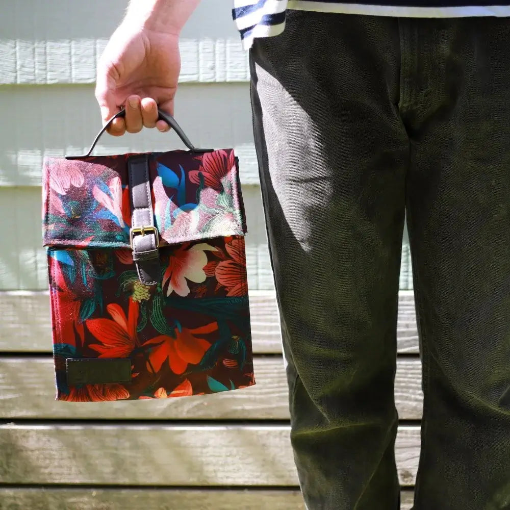 Lunch bag by Flox with bright print being held