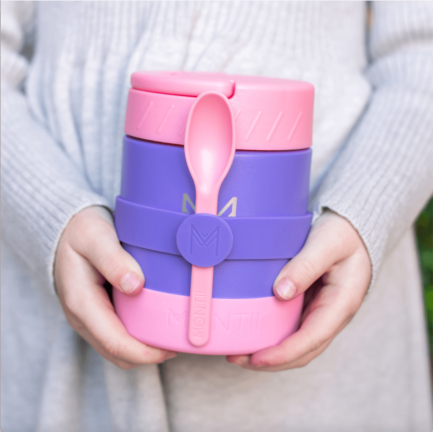 Montii NZ grape food jar with silicone band and cutlery being held by girl